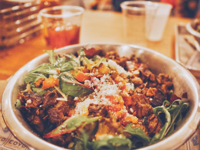 A close-up of a variety of colorful salads in a bowl.