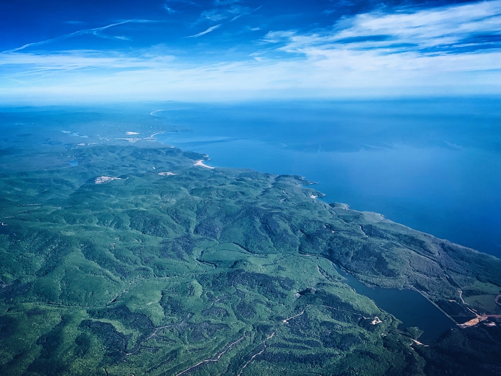 bird's eye view photography of green field under blue sky