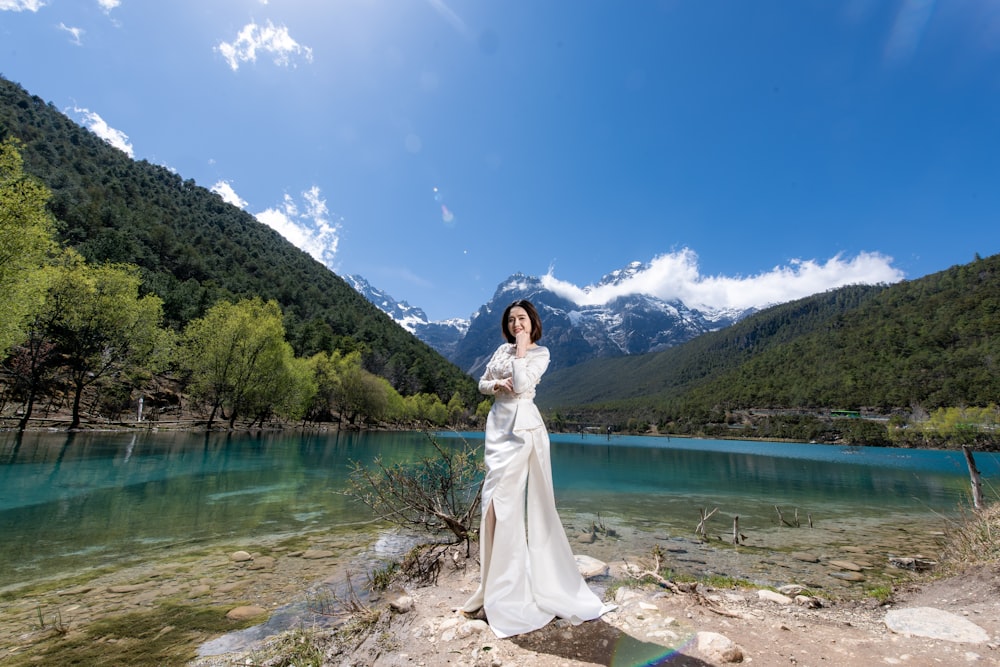woman standing beside lake during daytime