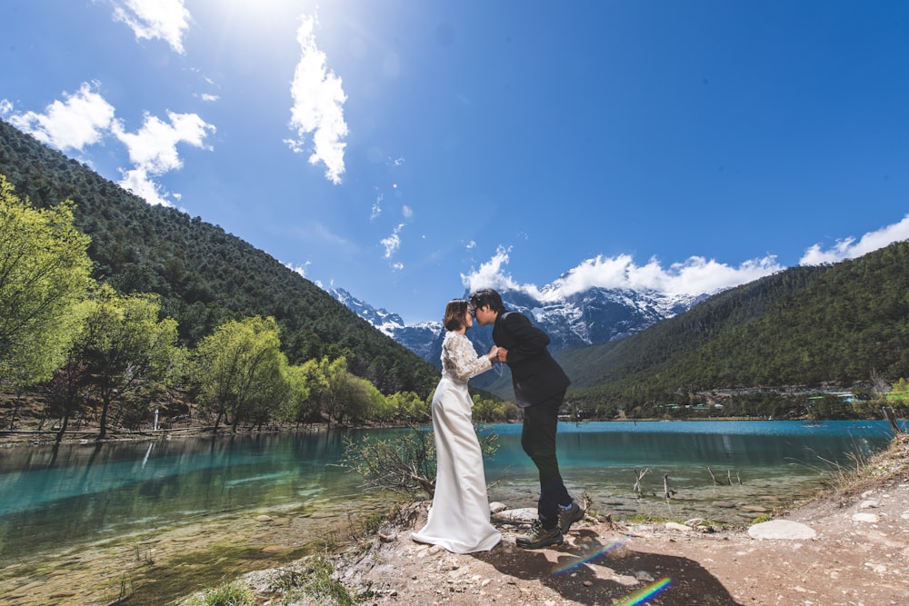 man and woman near lake