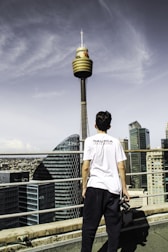 A reporter holding a microphone with Karachi’s skyline behind, capturing live news.