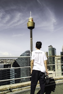A reporter holding a microphone with Karachi’s skyline behind, capturing live news.