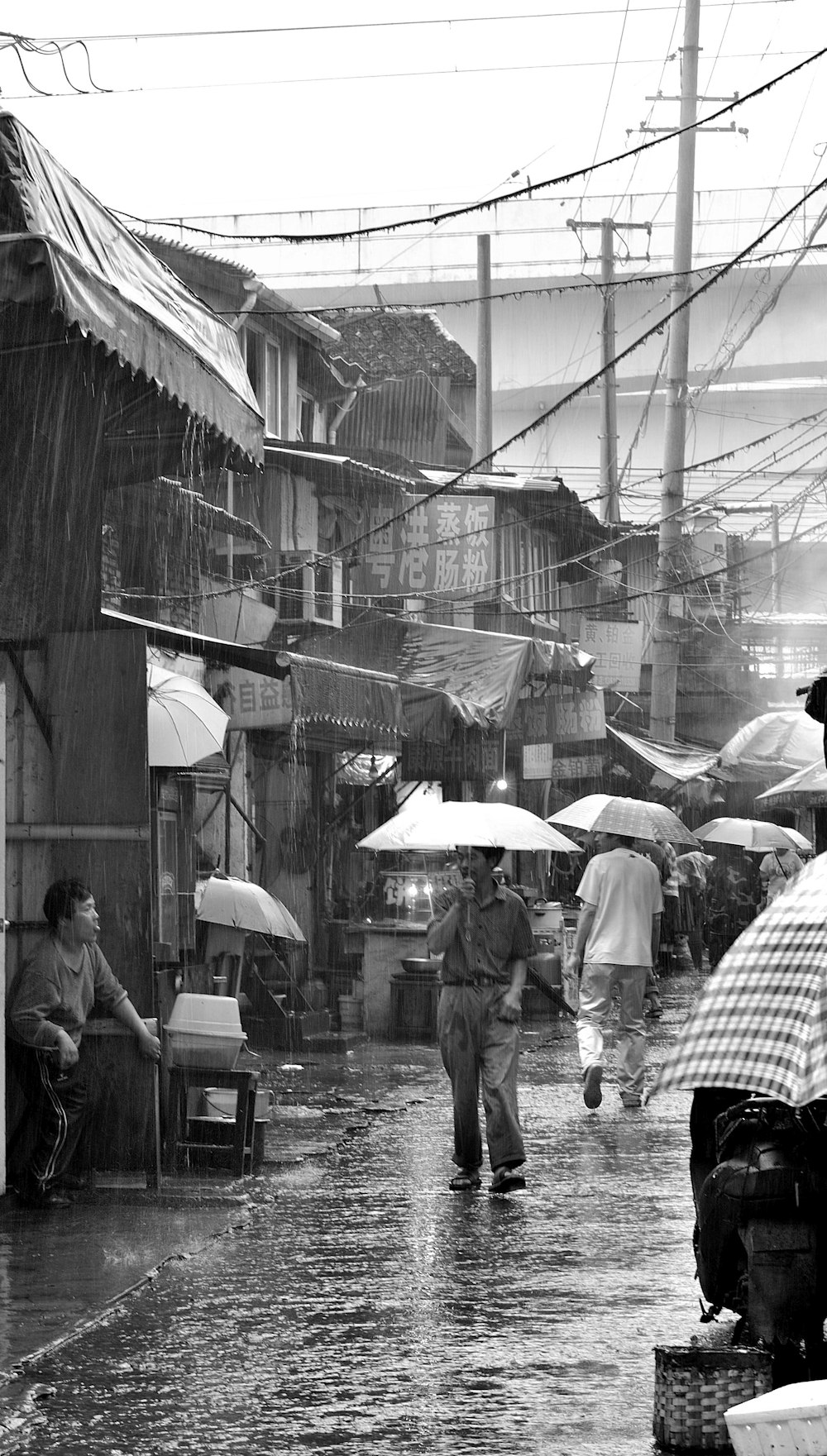 grayscale photography of man holding umbrella