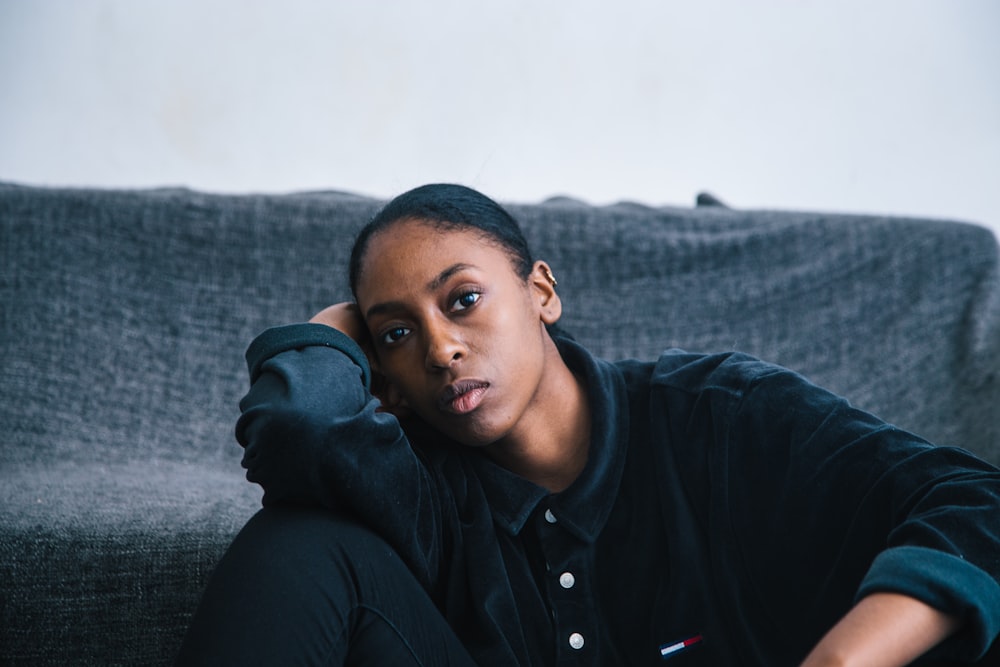 woman sitting beside black textile