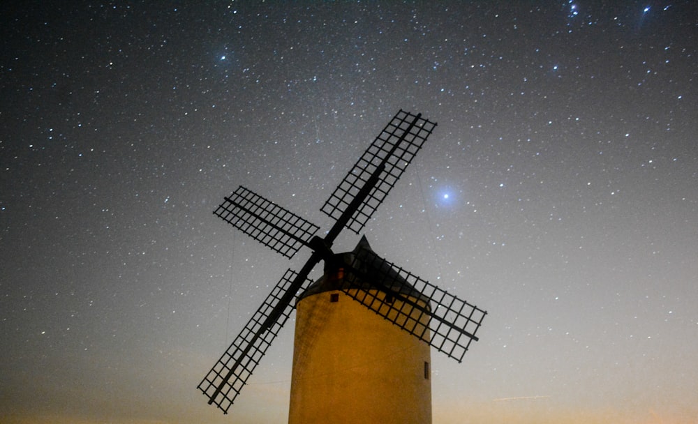 black windmill under stars