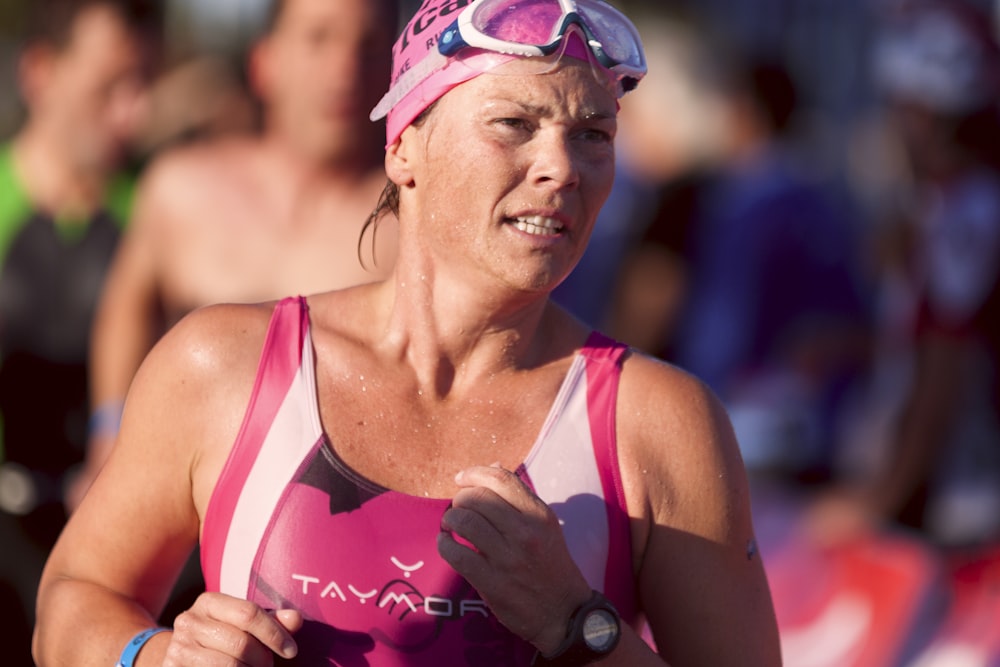 woman wearing pink and white tank top and goggles