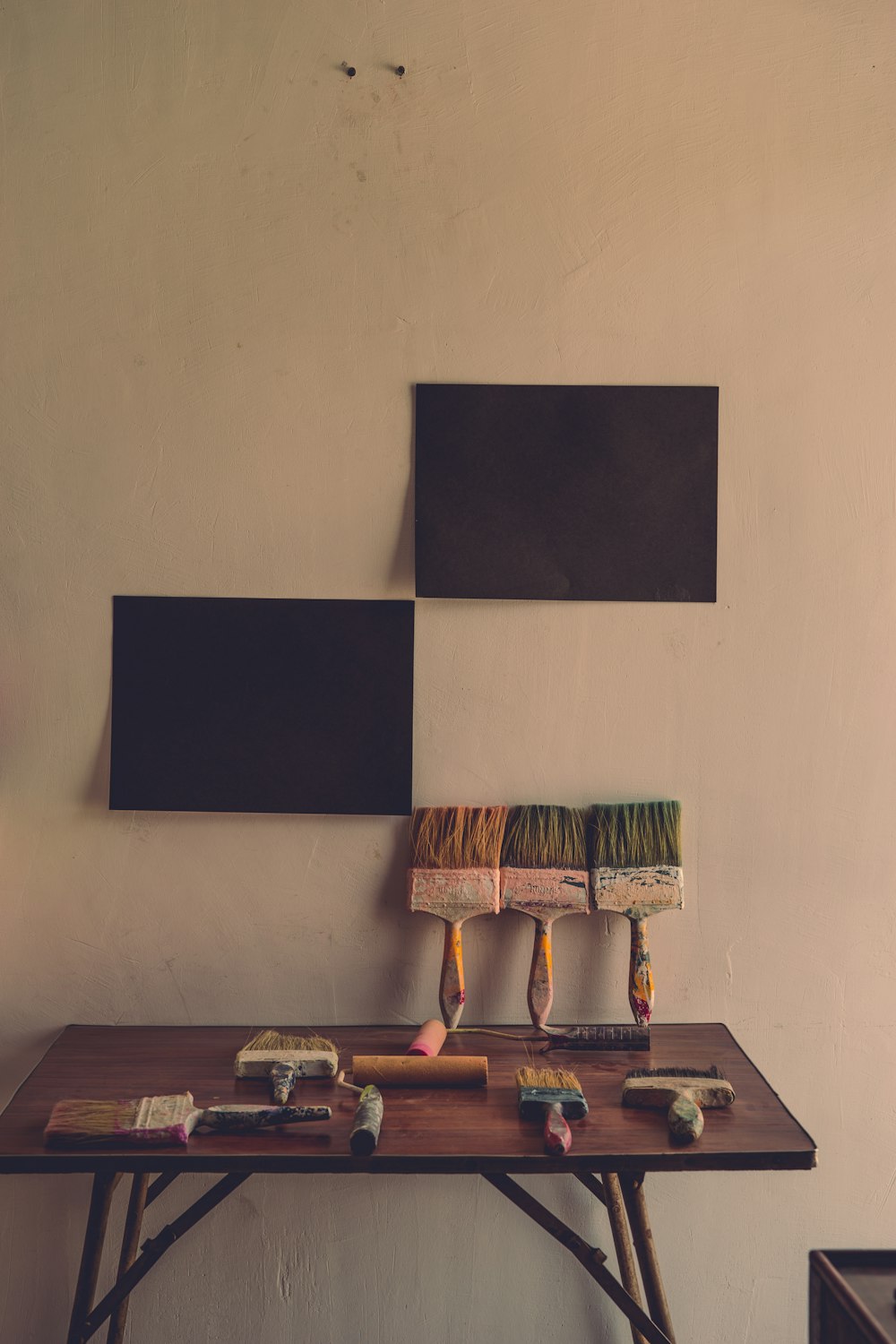 rectangular brown wooden table beside wall