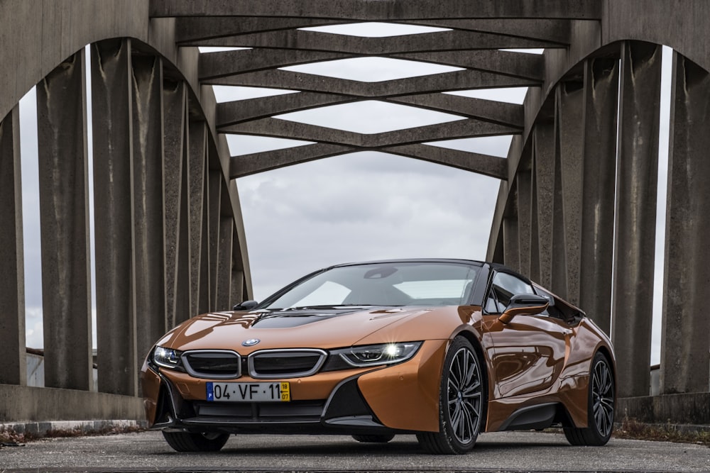 orange BMW coupe parking near road