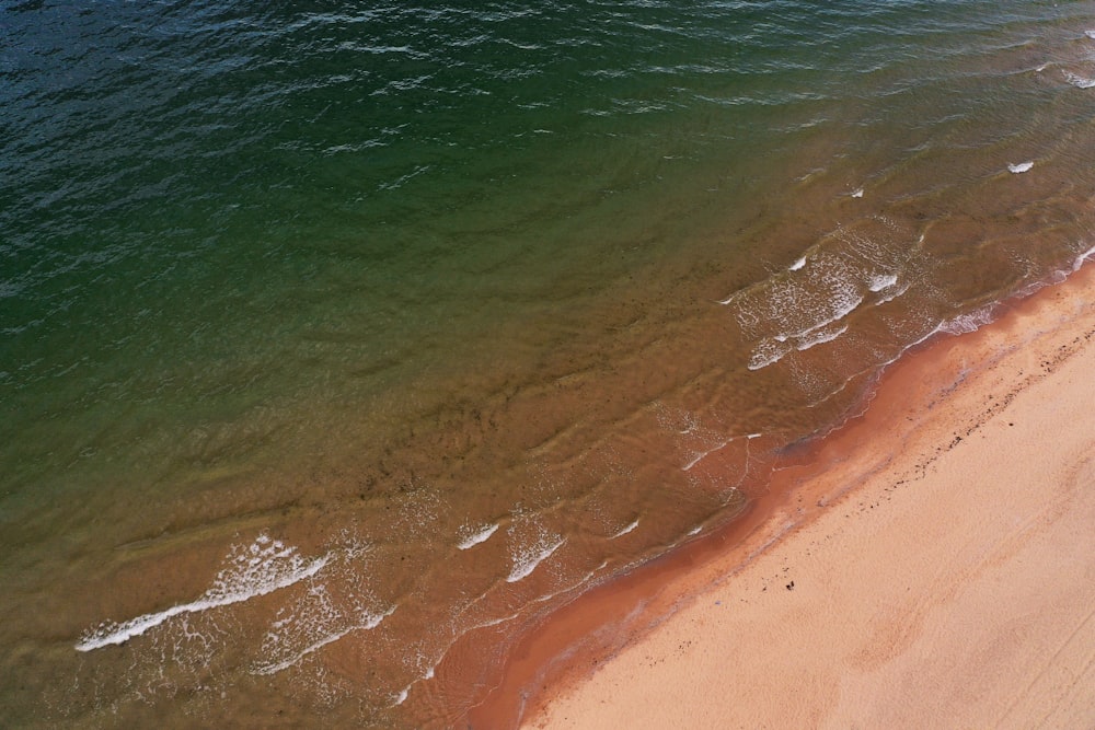 an aerial view of a sandy beach and ocean