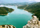 Panoramic view of the adventure park nestled between the lake and towering mountains.