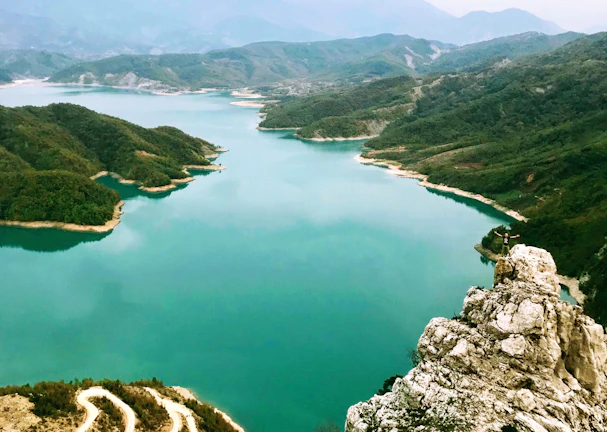 Panoramic view of the adventure park nestled between the lake and towering mountains.