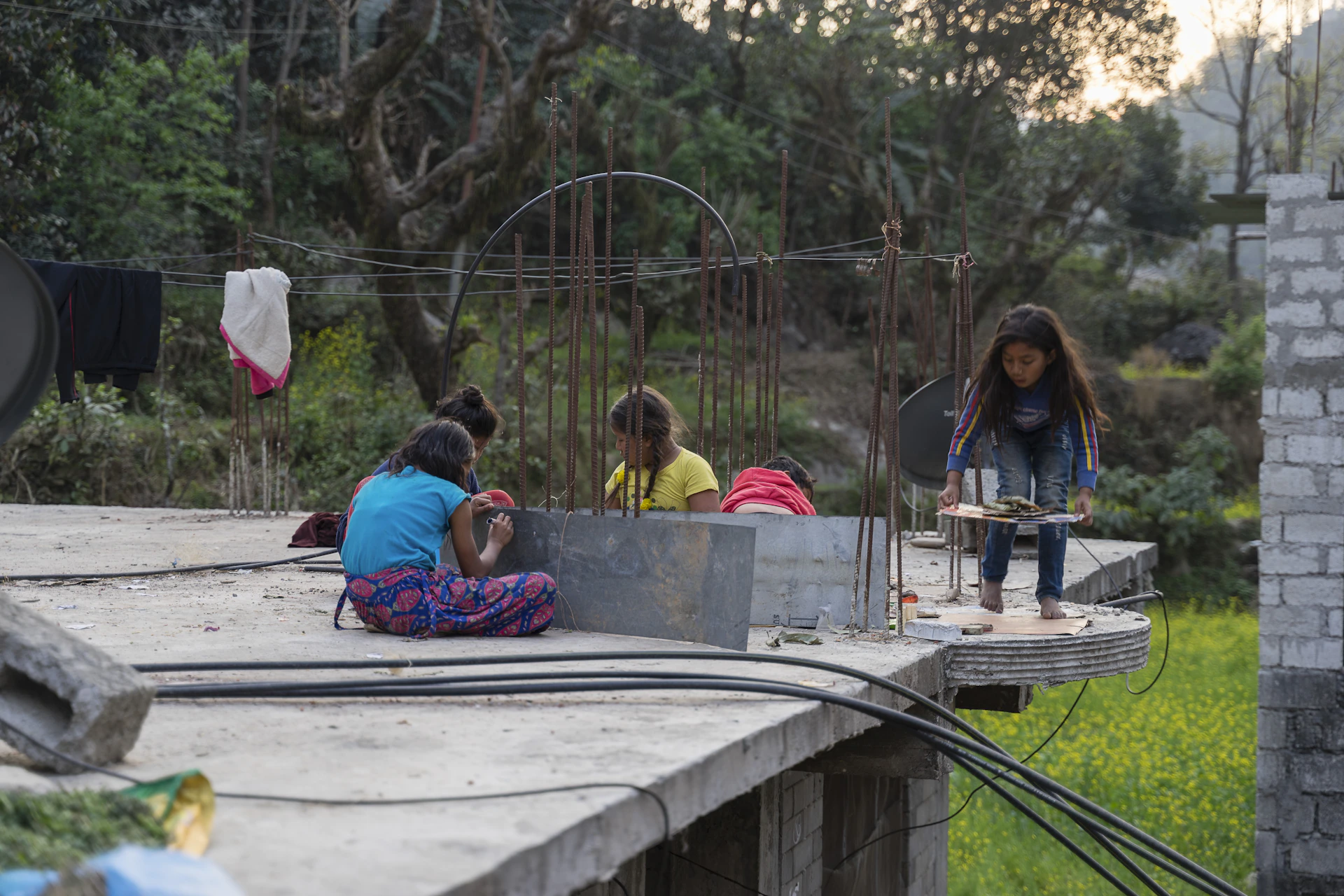 Children playing near a recently built sanitation facility, reflecting improved rural infrastructure and hygiene.