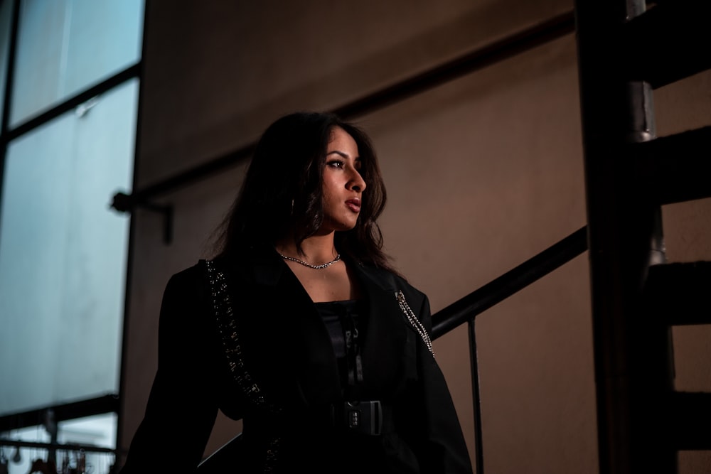 woman in black long sleeved dress in stairway