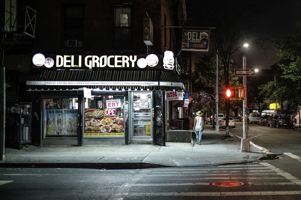 Deli Grocery near road at night time