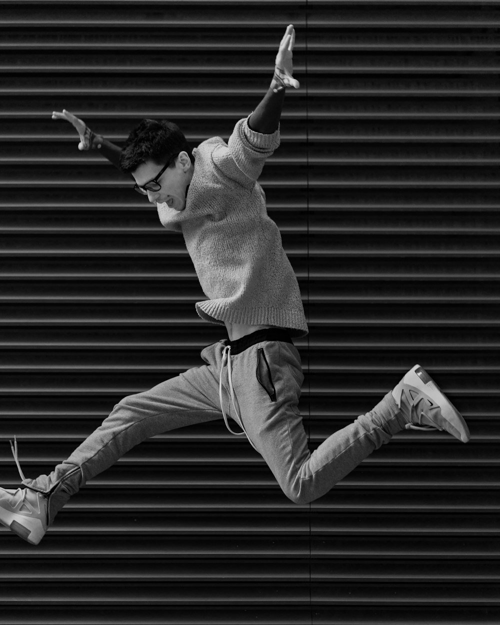 grayscale photography of person jumping