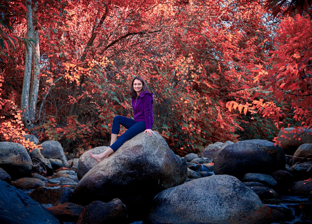 woman seated on rock formation