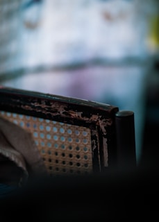 Photo of a vintage wooden chair with a worn leather seat