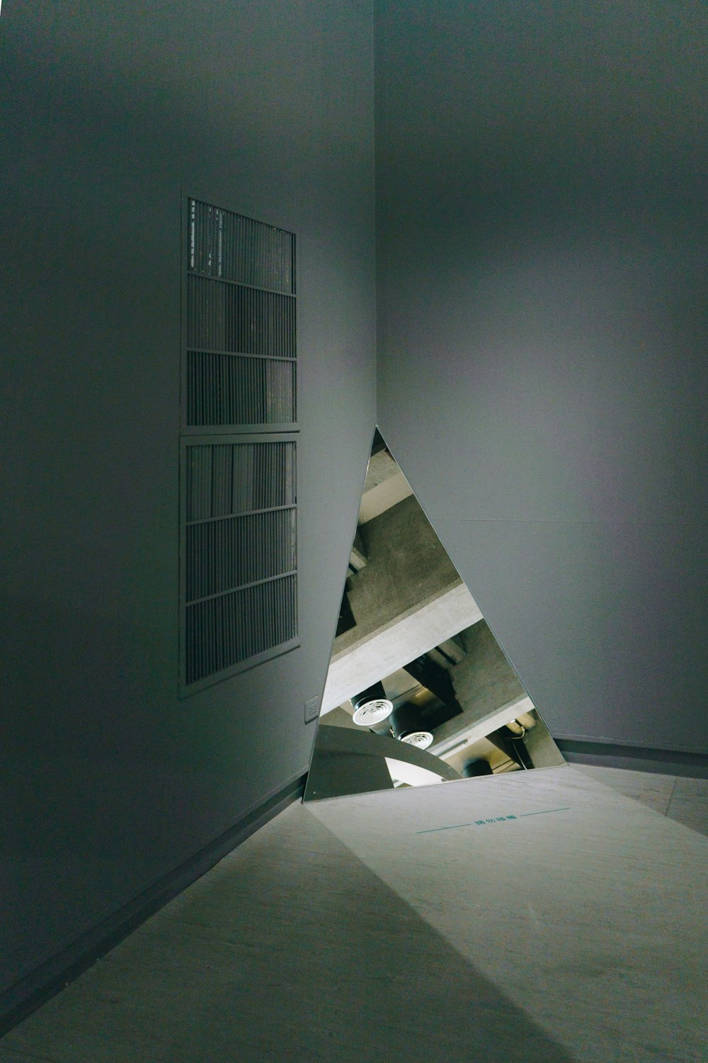 a room with a triangle shaped object in the middle of it