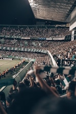 A lively crowd cheering at a packed London sports stadium during a thrilling match.