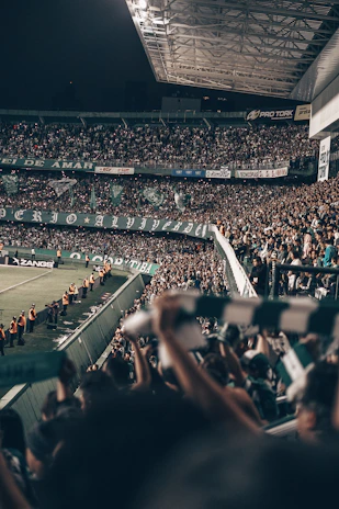 A panoramic view of the club's stadium filled with cheering fans wearing orange colors.