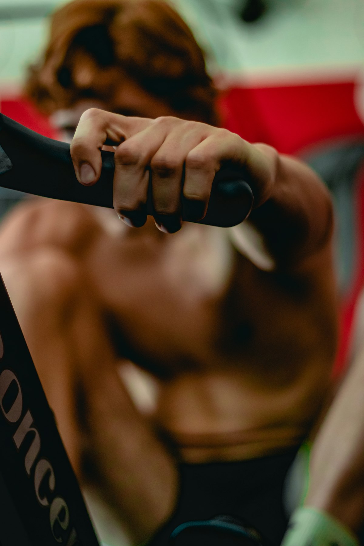 A person training on a rowing machine at a CrossFit gym