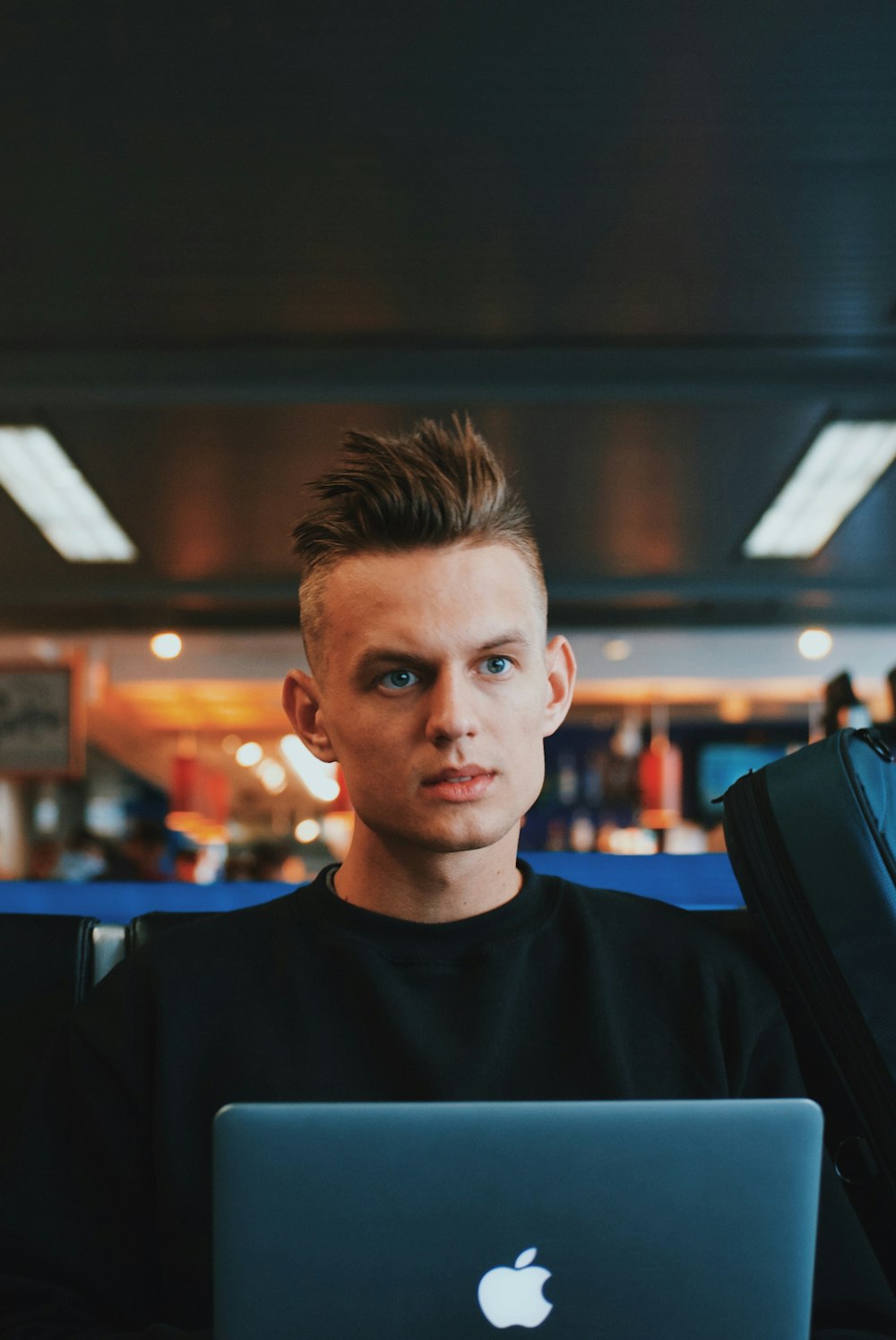 man wearing black crew-neck dress