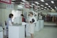 woman wearing white dress standing near the counter