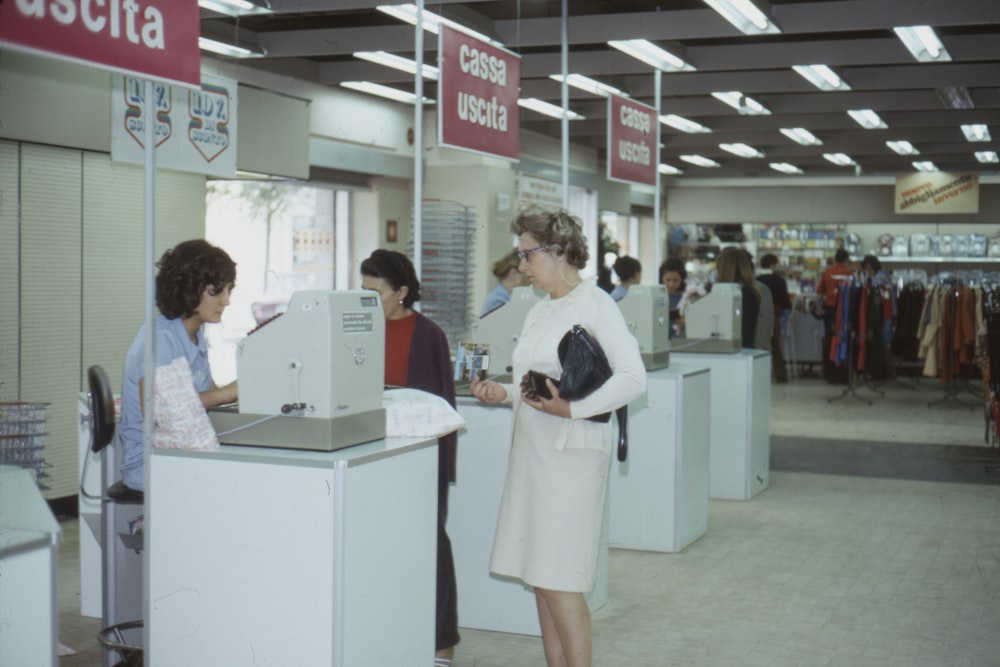 woman wearing white dress standing near the counter