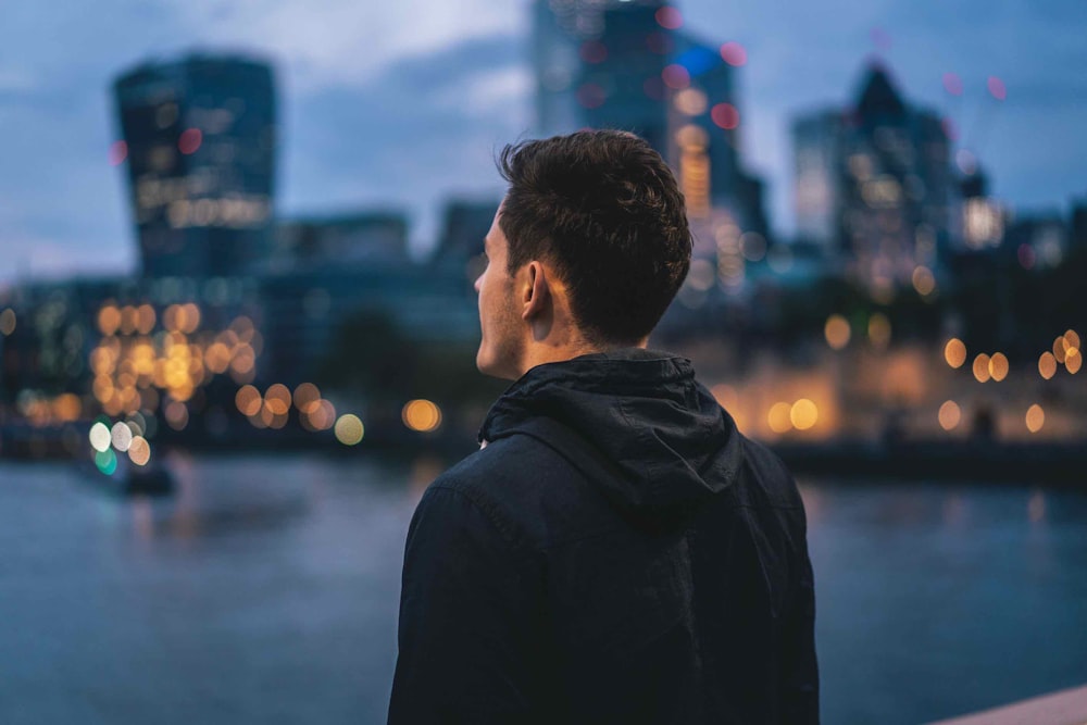 man standing and facing back