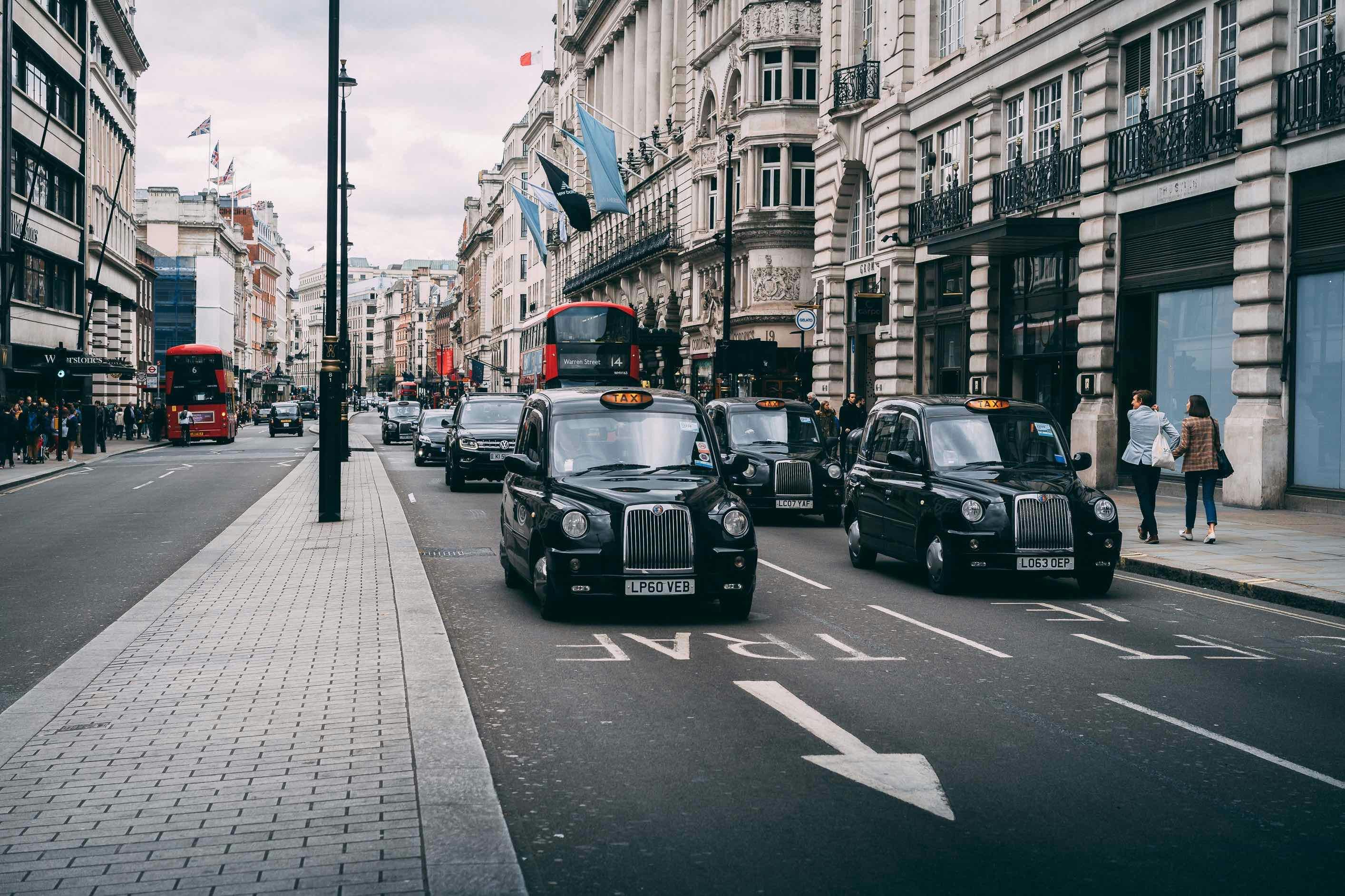 vehicles on road between buildings