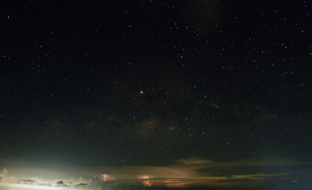 the night sky with stars and clouds