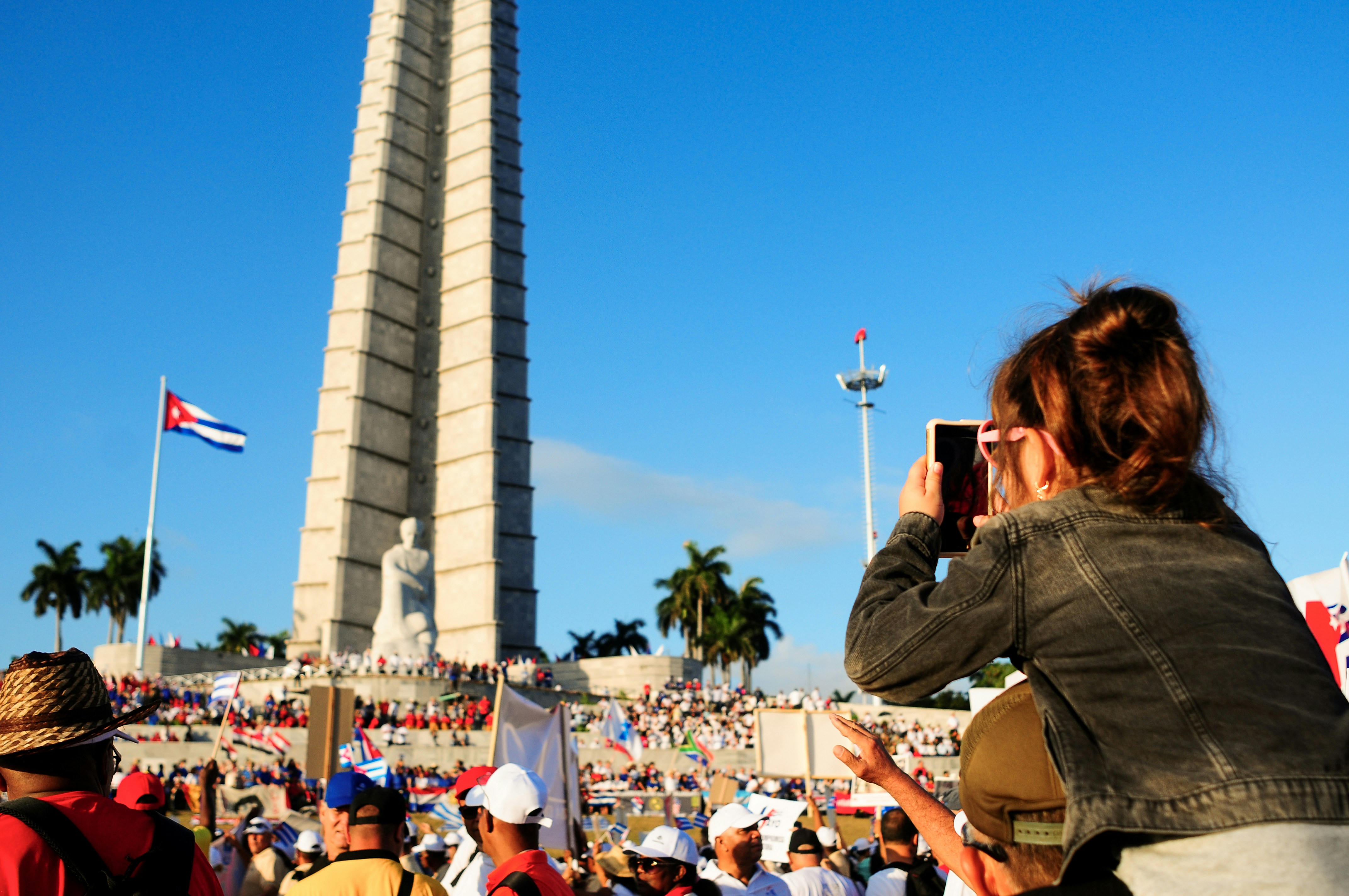 group of people taking photo of grey concrete tower