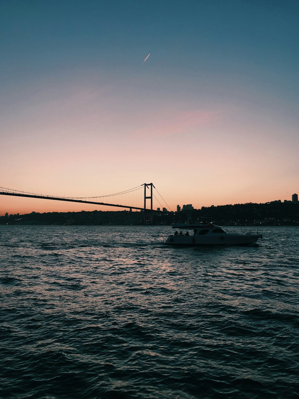 a boat in the water near a bridge