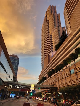 A bustling cityscape at sunset highlighting modern buildings developed by Urbanrise Enterprises.