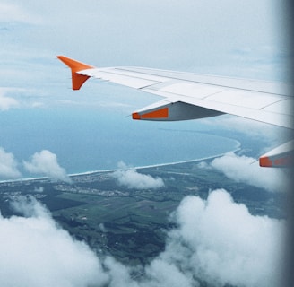 white airplane flying during daytime