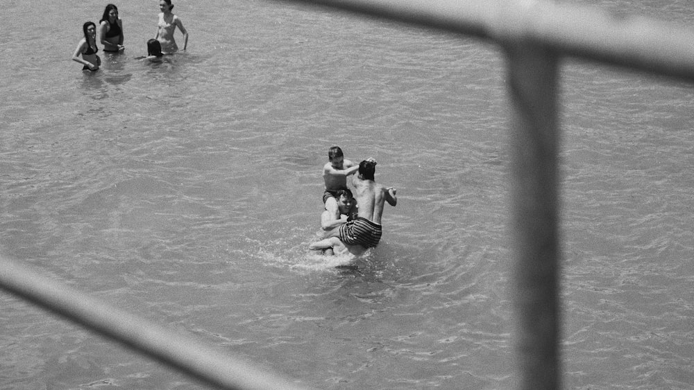 group of men playing at the beach