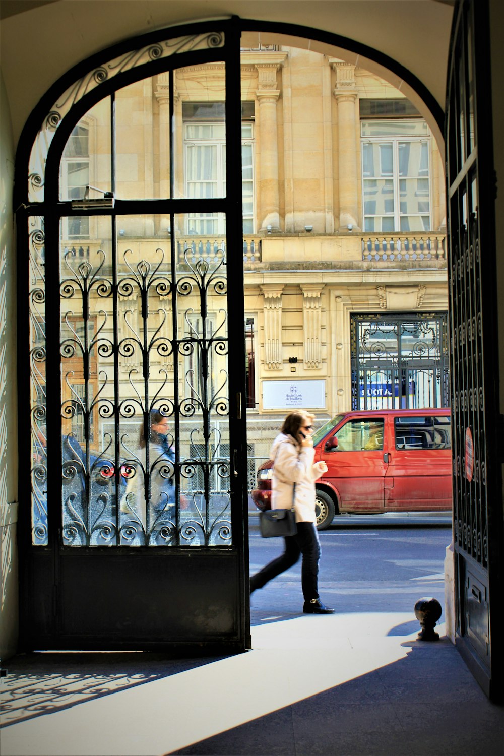 people passing by black metal gate