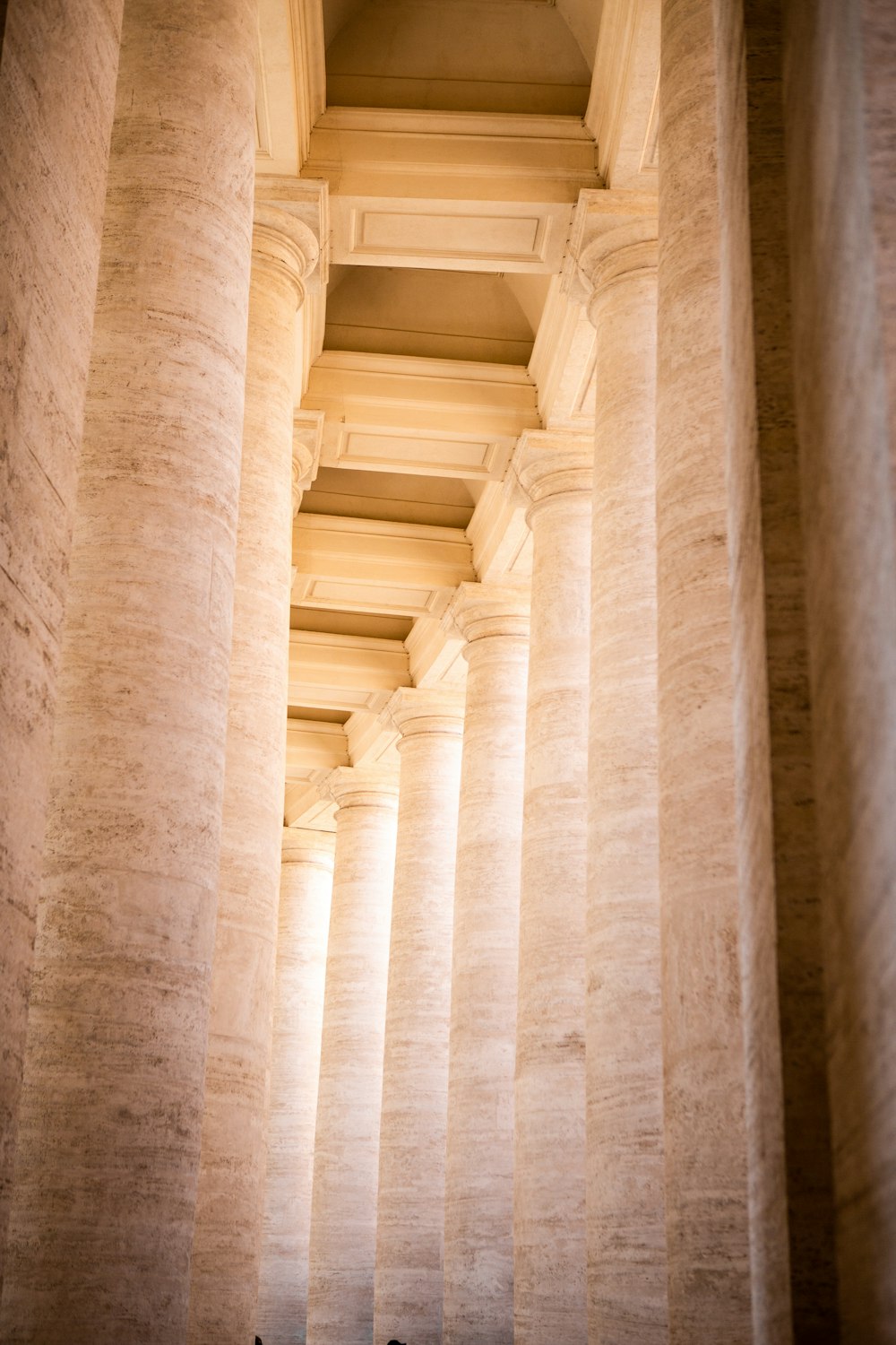 a group of people standing next to each other under columns