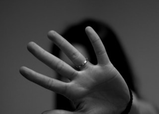 woman showing left hand with wedding band
