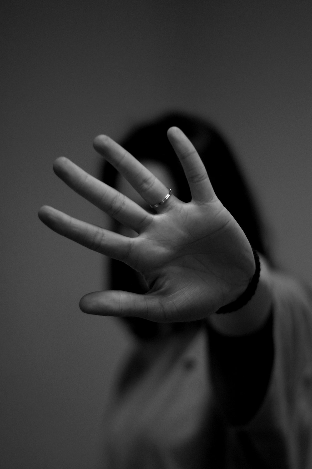 woman showing left hand with wedding band