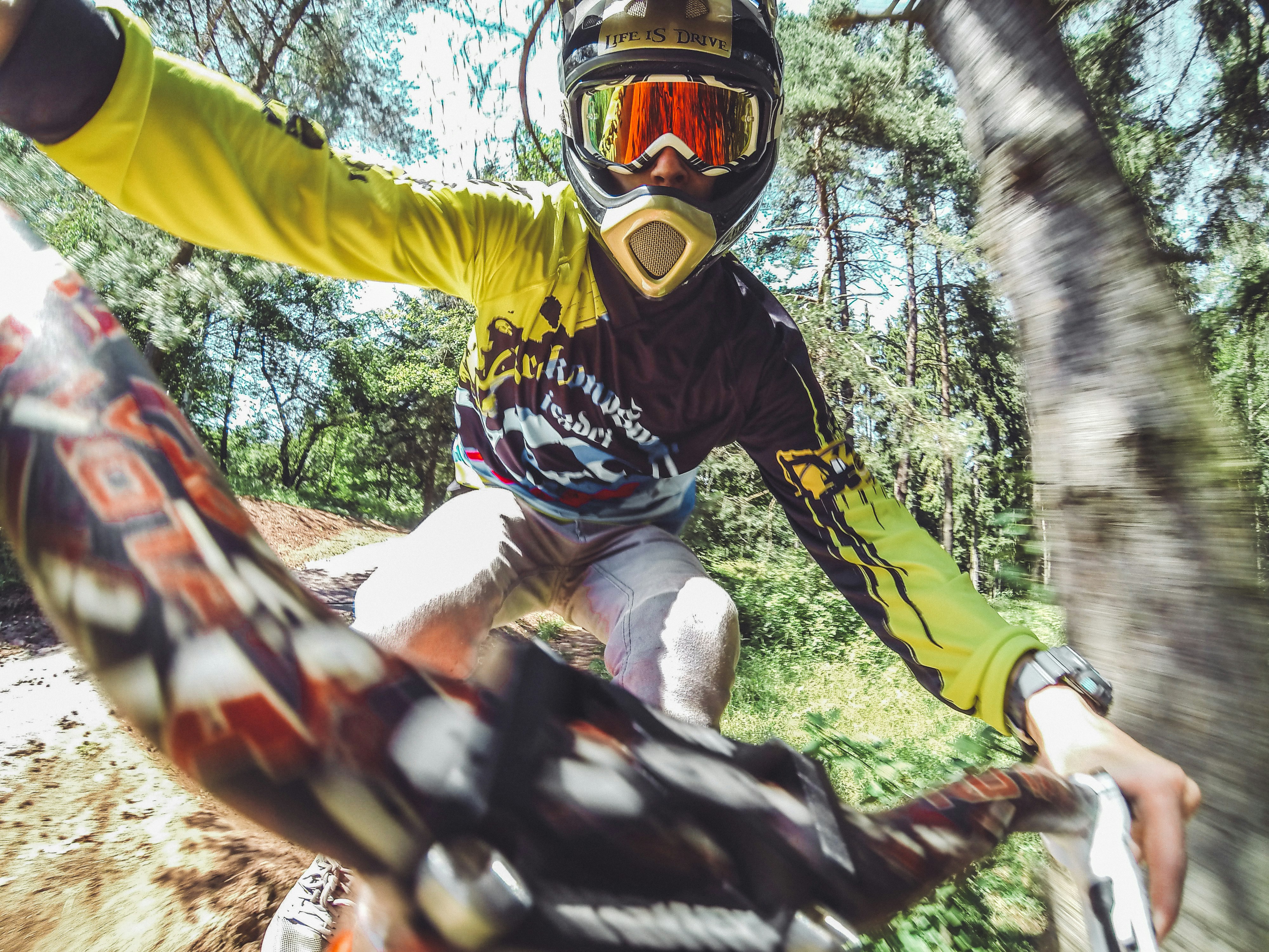 MTB Rider jumping in the forrest in high speed