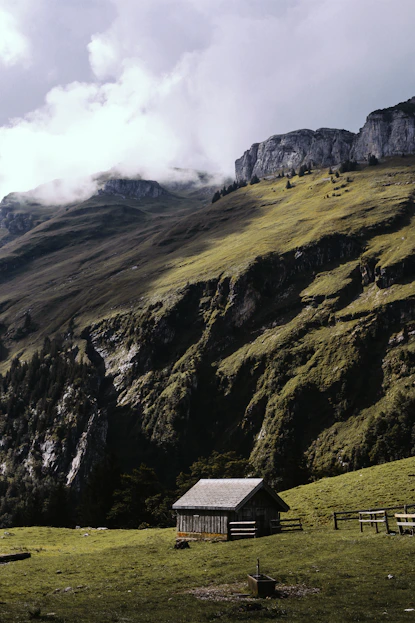 landscape photo of cabin near mountain during daytime