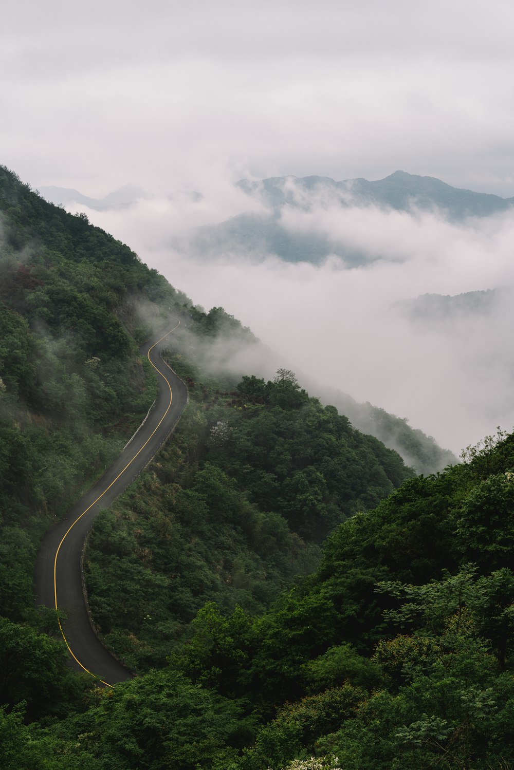 landscape photo of road beside mountains during daytime