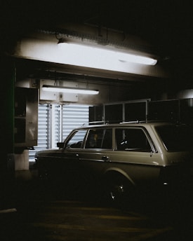 gray car parked beside shutter door