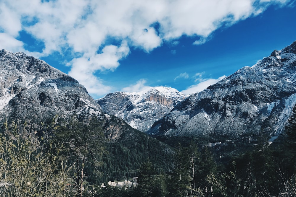 mountain covered with snow under blue and white skies