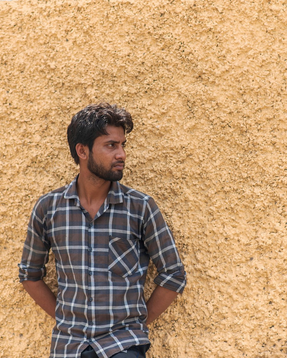 man leaning on wall