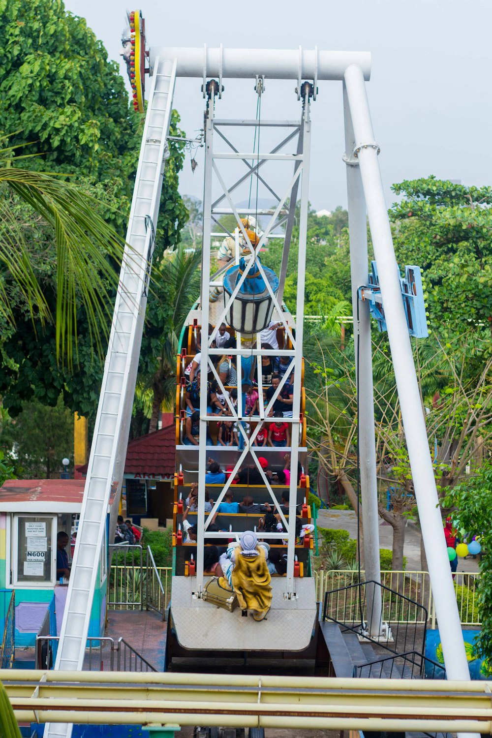 people riding swing boat at carnival