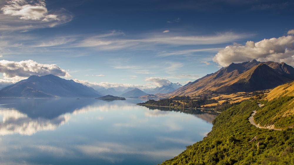 landscape photo of mountains near body of water during daytime