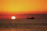 A vibrant sunset over the Sea of Cortez with a fishing boat silhouetted against the colorful sky.