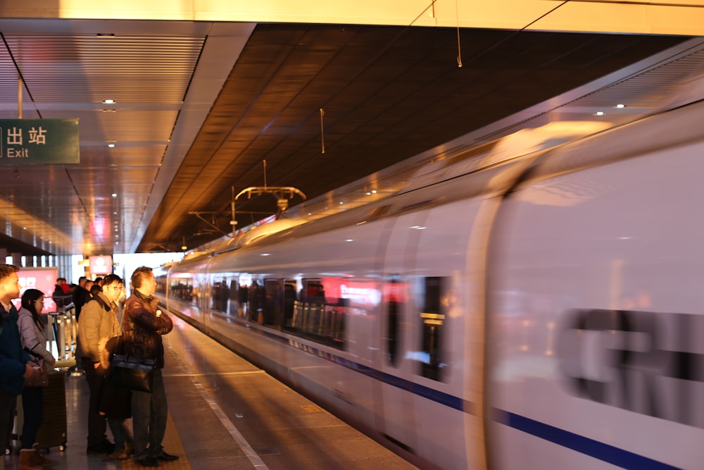 time lapse photo of white train passing by